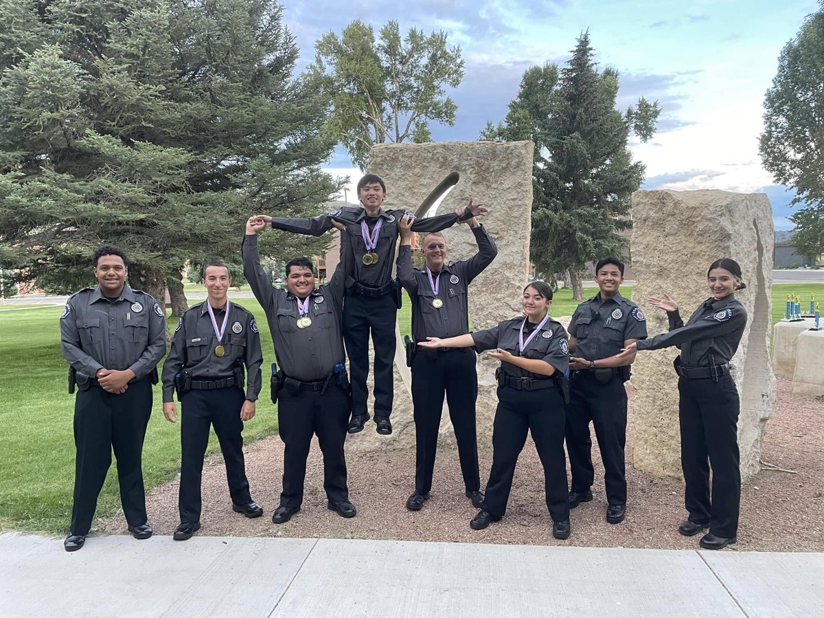 Explorers wearing gold medals lift a teammate in celebration