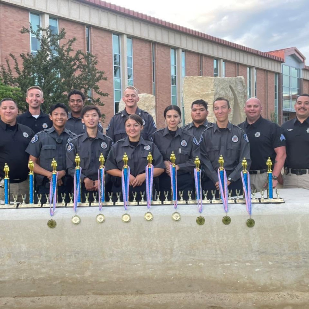 Explorers and advisors with a full table of team trophies and medals