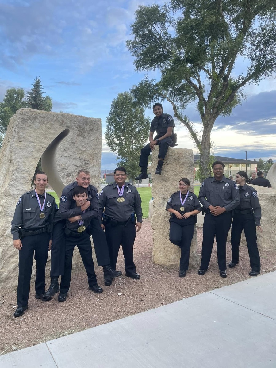 The Explorer team poses playfully on stone monuments after awards night