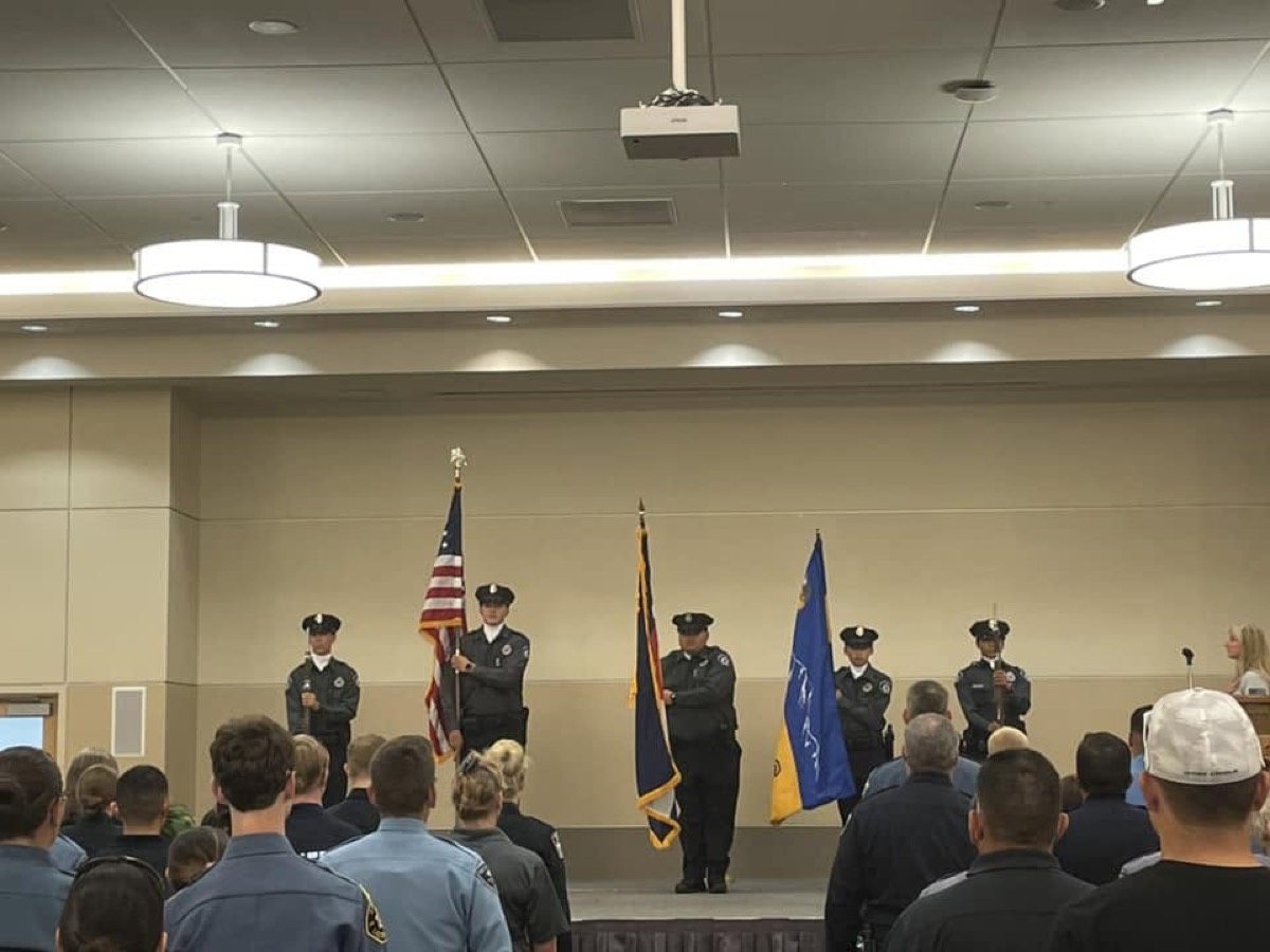 The Explorer color guard presents the colors on stage at a graduation ceremony