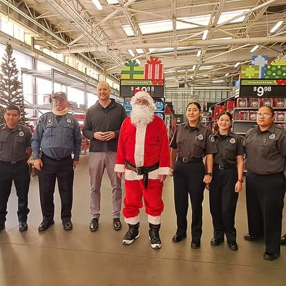 Explorers and Denver officers with Santa at a holiday community event